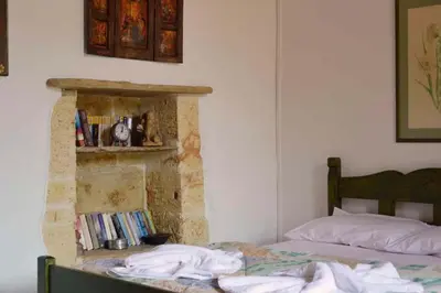 a bedroom with a bed and a book shelf at Apanemia in Vamos
