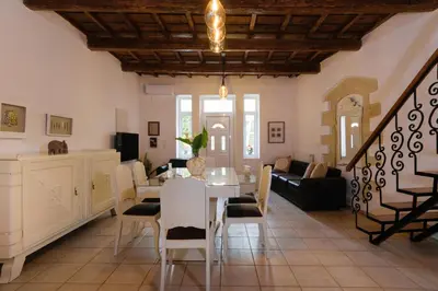 a dining room and living room with a table and chairs at Diogenis Residence Euphoria in Arménoi