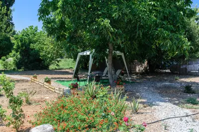 a swing under a tree in a garden at Diogenis Residence Euphoria in Arménoi