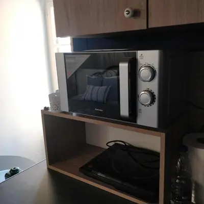 a microwave oven sitting on a shelf in a kitchen at Old Port - Bellavista Studio in Chania Town
