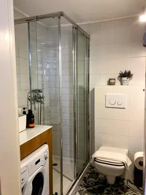 a bathroom with a toilet and a glass shower at Old Port - Bellavista Studio in Chania Town
