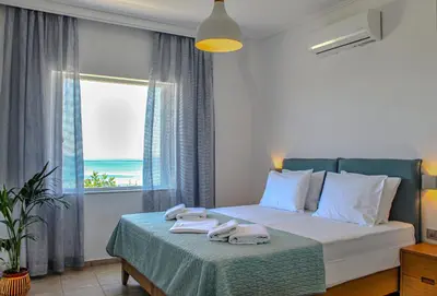 a bedroom with a bed with towels on it at Endless Blue in Palaiochóra