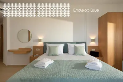 a bedroom with a bed with two towels on it at Endless Blue in Palaiochóra