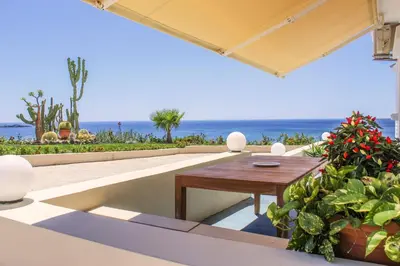 a patio with a table and a view of the ocean at Endless Blue in Palaiochóra