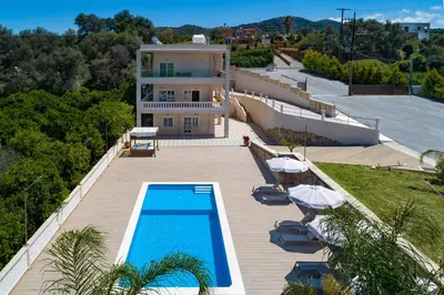 a villa with a swimming pool and a house at Queen Electra with pool and tennis court in Alikianós