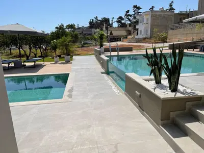 a swimming pool in the middle of a building at Twins Apartments in Plataniás