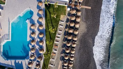 an overhead view of a group of cars parked on a beach at Solimar White Pearl - Adults Only in Kolymvari