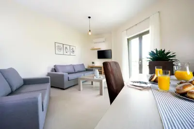a living room with a table and a couch at Alexandra Apartment in Daratso