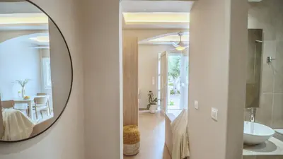 a bathroom with a mirror and a sink in a room at Fata Morgana Studios & Apartments in Frangokastello