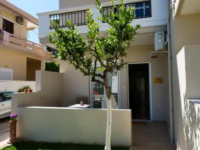 a small tree in front of a building at Cosy Apartments Daphne in Daratso