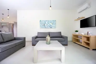 a living room with a couch and a table at Ariadne Apartment in Daratso
