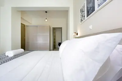 a white bedroom with a large white bed at Ariadne Apartment in Daratso