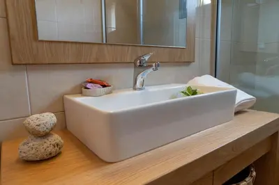 a bathroom with a white sink and a mirror at YaChara Villa in Kissamos