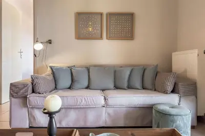 a living room with a couch with pillows on it at YaChara Villa in Kissamos