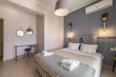 a bedroom with a bed with two towels on it at YaChara Villa in Kissamos