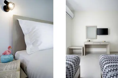 a bedroom with a bed and a desk with a mirror at Ellie Apartment in Daratso