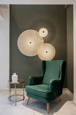 a green chair and two lights and a table at M City Hotel in Chania Town