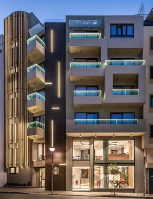 an apartment building with balconies and a street light at M City Hotel in Chania Town