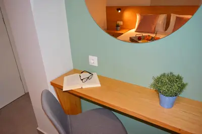 a room with a desk with a mirror and a bed at Balos Residence private pool Seafront Seaview in Kissamos