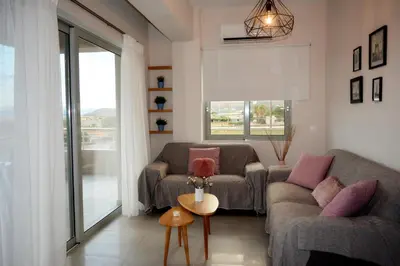 a living room with two couches and a table at Balos Residence private pool Seafront Seaview in Kissamos
