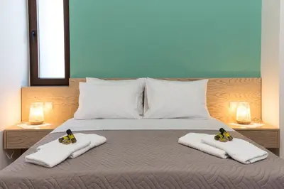 a bedroom with a bed with two pairs of shoes on towels at Dream Sea House villa Falassarna in Falasarna