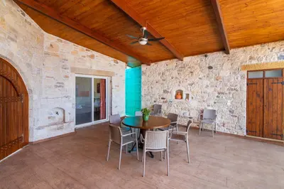 a dining room with a table and chairs at Dream Sea House villa Falassarna in Falasarna