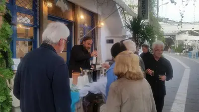 a group of people standing outside of a store at Lefka Ori in Khóra Sfakíon