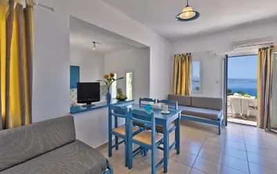 a living room with a blue table and a couch at Tersanas Village Apartments in Tersanas