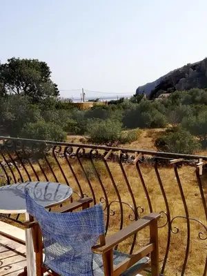 a couple of chairs and a table on a balcony at CAPTAIN GEORGE in Sougia