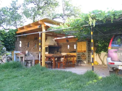 a patio with a table and chairs under a building at CAPTAIN GEORGE in Sougia