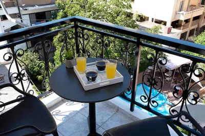 a tray of orange juice on a table on a balcony at Superior Central Studio in Chania Town