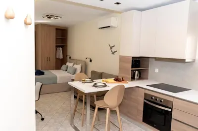 a kitchen with a table and chairs in a room at Superior Central Studio in Chania Town