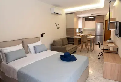 a bedroom with a bed with a blue hat on it at Superior Central Studio in Chania Town