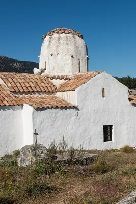 a church with a cross on the side of it at ARADENA TRADITIONAL House 1 in Arádhaina