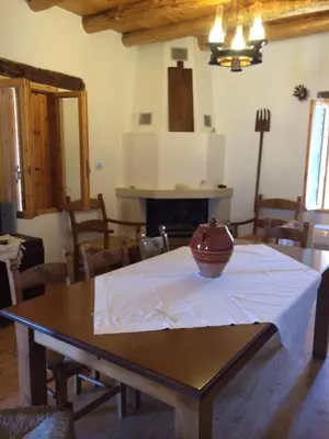 a dining room with a table with a vase on it at ARADENA TRADITIONAL House 1 in Arádhaina