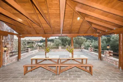 a wooden pavilion with a table on a patio at ARADENA TRADITIONAL House 1 in Arádhaina