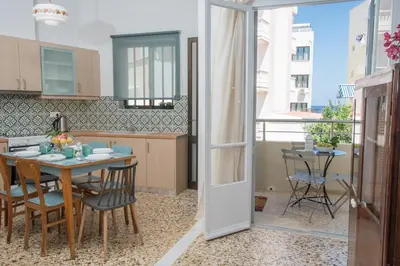 a kitchen and dining room with a table and chairs at The Romantic Beach House in Chania Town