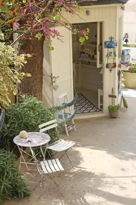 a patio with two chairs and a table and a tree at Effi Apartments in Plataniás