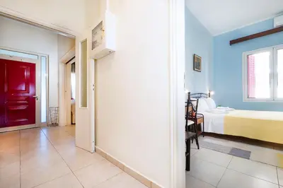 a room with a bed and a bedroom with blue walls at Niki House in Chania Town