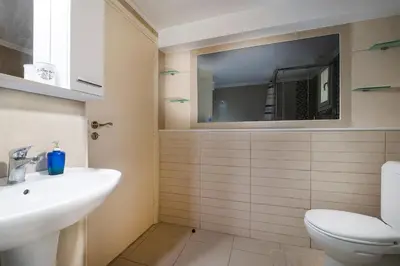 a bathroom with a sink and a toilet at Niki House in Chania Town