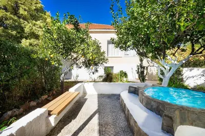 a swimming pool with a bench next to a house at Niki House in Chania Town