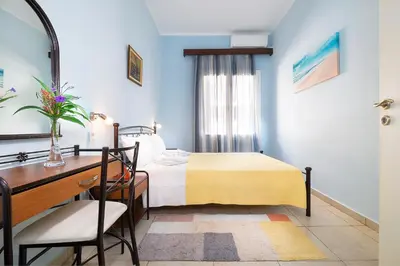a bedroom with a bed and a desk and a mirror at Niki House in Chania Town