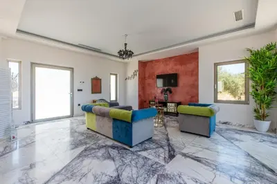 a living room with two couches and a table at Villa Kounoupidiana in Kounoupidhianá