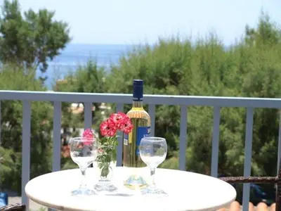 a table with two wine glasses and a bottle at Santa Irene in Sougia