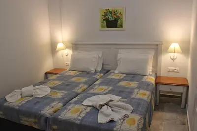 a bedroom with a bed with towels on it at Santa Irene in Sougia
