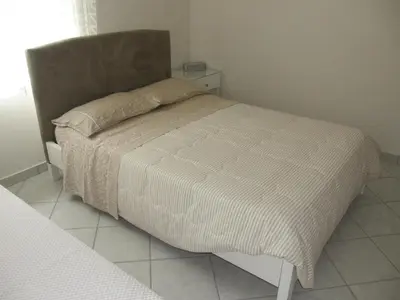 a bedroom with a bed with a white comforter at Panorama Country Residence in Tzitzifés