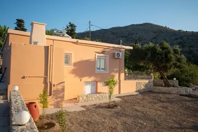 a house with a hill in the background at Panorama Country Residence in Tzitzifés