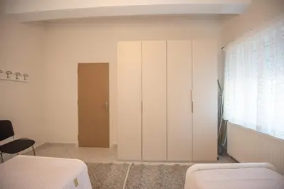 a bedroom with a large white cabinet and a window at Panorama Country Residence in Tzitzifés