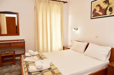 a hotel room with a bed with towels on it at Filoxenia Apartments 2 in Palaiochóra