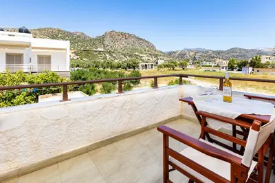 a patio with a table and chairs on a balcony at Filoxenia Apartments 2 in Palaiochóra
